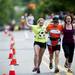 A Dexter-Ann Arbor runner crosses the finish line with support on Sunday, June 2. Daniel Brenner I AnnArbor.com